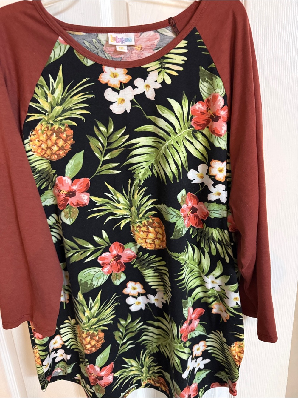 LuLaRoe Black Tropical Pineapple Raglan Top with Rust Sleeves